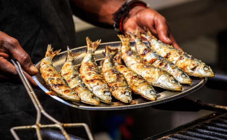 Why to visit Portugal: Savoring the essence of Portugal through a plate of grilled sardines.